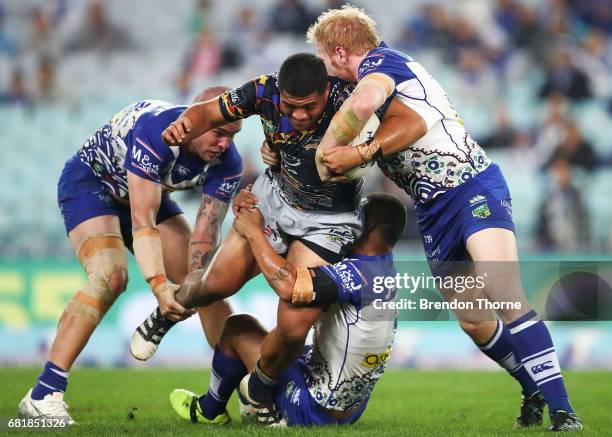 John Asiata of the Cowboys is tackled by the Bulldogs defence during the round 10 NRL match between the Canterbury Bulldogs and the North Queensland...