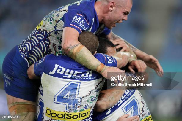 Bulldogs players celebrate a try during the round 10 NRL match between the Canterbury Bulldogs and the North Queensland Cowboys at ANZ Stadium on May...