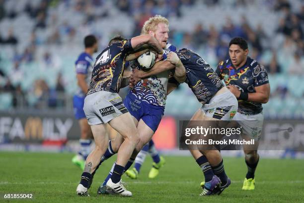 James Graham of the Bulldogs is tackled during the round 10 NRL match between the Canterbury Bulldogs and the North Queensland Cowboys at ANZ Stadium...