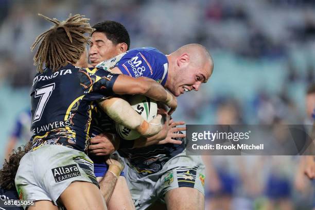 Josh Morris of the Bulldogs is tackled during the round 10 NRL match between the Canterbury Bulldogs and the North Queensland Cowboys at ANZ Stadium...