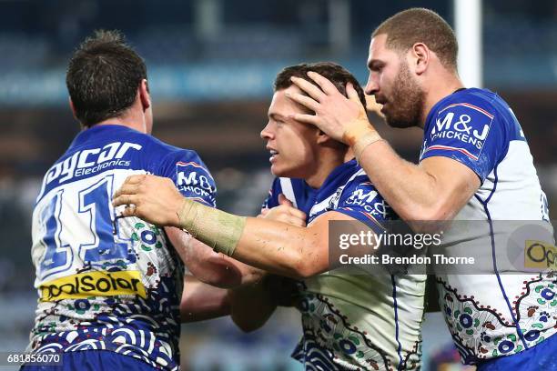 Kerrod Holland of the Bulldogs celebrates with team mates after scoring a try during the round 10 NRL match between the Canterbury Bulldogs and the...