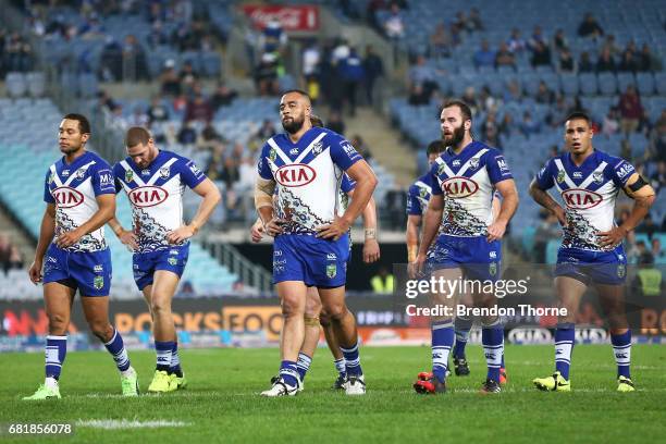 Bulldogs players walk from the field during the round 10 NRL match between the Canterbury Bulldogs and the North Queensland Cowboys at ANZ Stadium on...