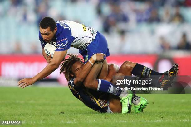 Moses Mbye of the Bulldogs is tackled by Ray Thompson of the Cowboys during the round 10 NRL match between the Canterbury Bulldogs and the North...