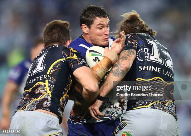 Josh Jackson of the Bulldogs is tackled by the Cowboys defence during the round 10 NRL match between the Canterbury Bulldogs and the North Queensland...