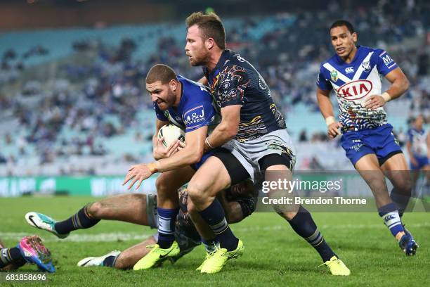 Brenko Lee of the Bulldogs is tackled by the Cowboys defence during the round 10 NRL match between the Canterbury Bulldogs and the North Queensland...