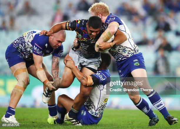 John Asiata of the Cowboys is tackled by the Bulldogs defence during the round 10 NRL match between the Canterbury Bulldogs and the North Queensland...