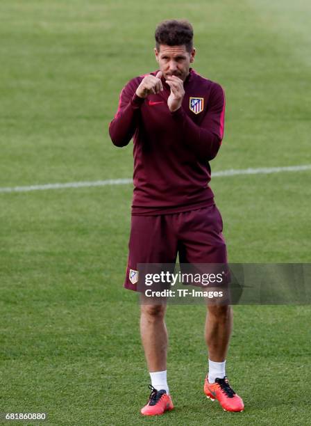 Head coach Diego Simeone of Atletico Madrid looks on during a training session ahead of the UEFA Champions League Semifinal Second leg match between...