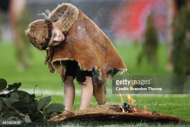 People take part in a smoking ceremony as part of the NRL Indigenous Round prior to the round 10 NRL match between the Canterbury Bulldogs and the...