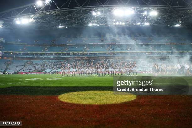 Cowboys players stand for the national anthem during the round 10 NRL match between the Canterbury Bulldogs and the North Queensland Cowboys at ANZ...