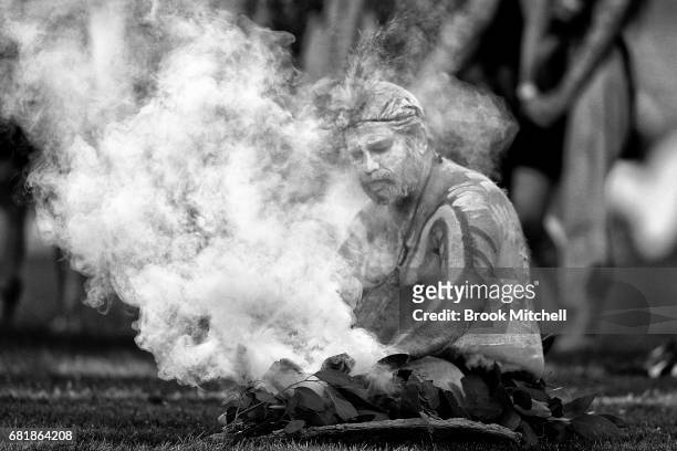 Man participates in a smoking ceremony before the round 10 NRL match between the Canterbury Bulldogs and the North Queensland Cowboys at ANZ Stadium...