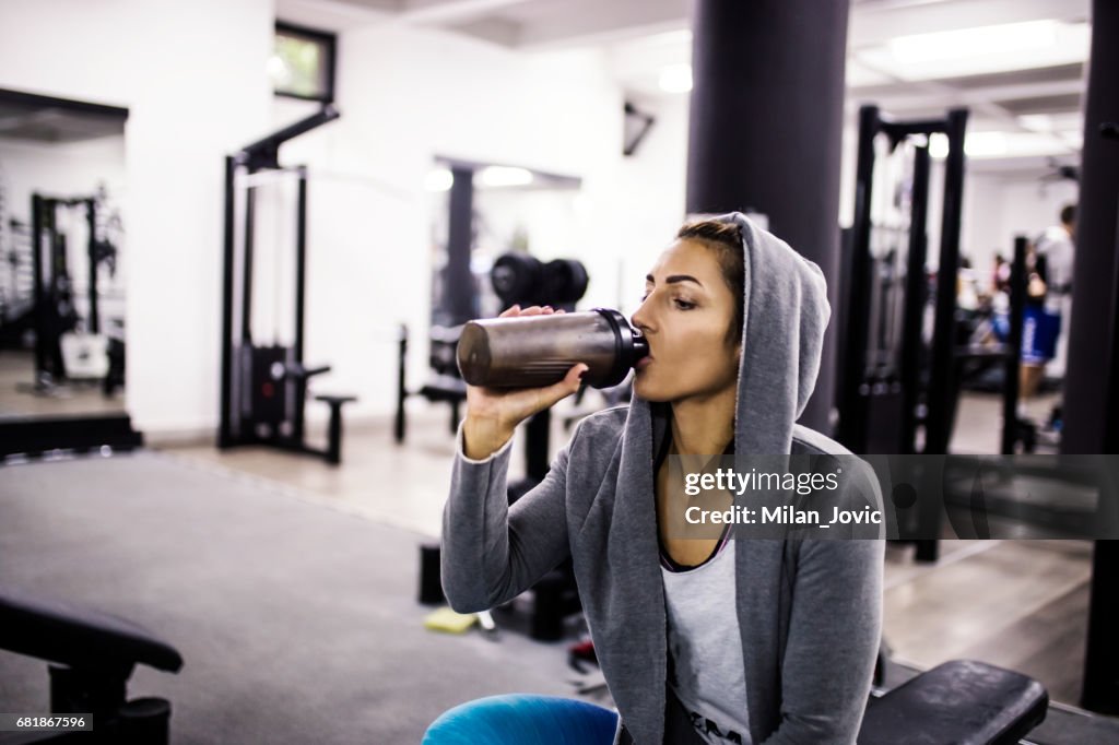 Bodybuilder girl relax after exhausting training