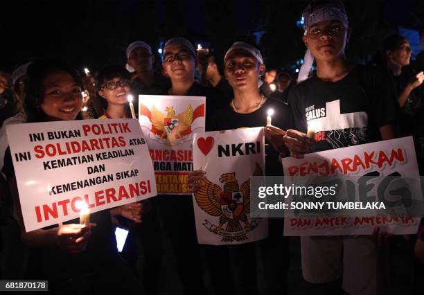 Thousands of Basuki Tjahaja Purnama, known by his nickname Ahok, hold candles to give their support for freedom from the accused of blasphemy in...