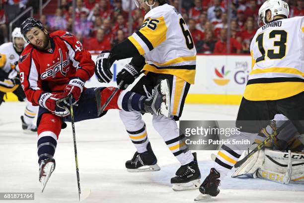 Tom Wilson of the Washington Capitals is checked by Ron Hainsey of the Pittsburgh Penguins in the first period in Game Seven of the Eastern...