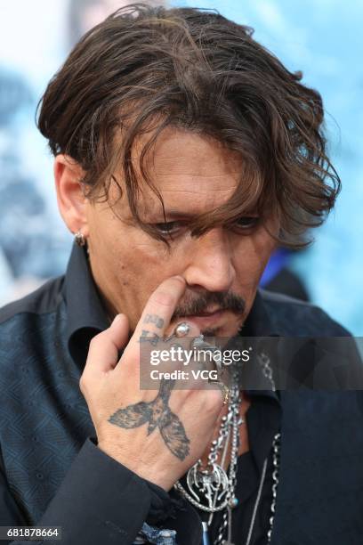 American actor Johnny Depp attends the premiere of film "Pirates of the Caribbean: Dead Men Tell No Tales" at Shanghai Disneyland Park on May 11,...