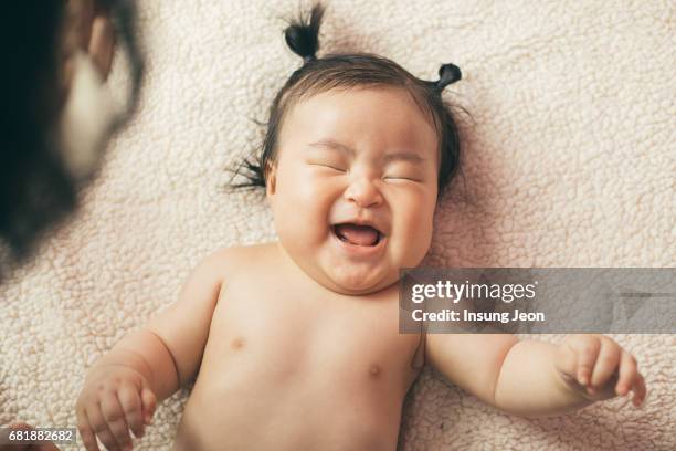 laughing baby girl - cheek stock pictures, royalty-free photos & images