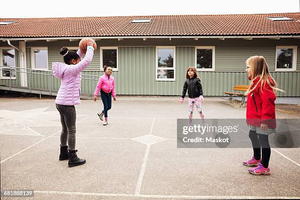 high angle view of children playing with ball in school playground - patio de colegio fotografías e imágenes de stock