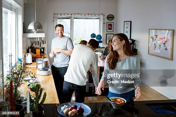 happy family preparing food in kitchen - carrying table stock pictures, royalty-free photos & images