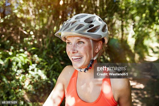 laughing young woman with bicycle helmet - cycling helmet fotografías e imágenes de stock