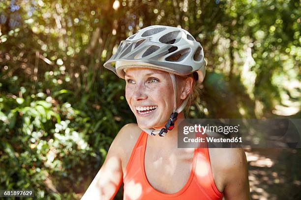 laughing young woman with bicycle helmet - cycling helmet stock pictures, royalty-free photos & images