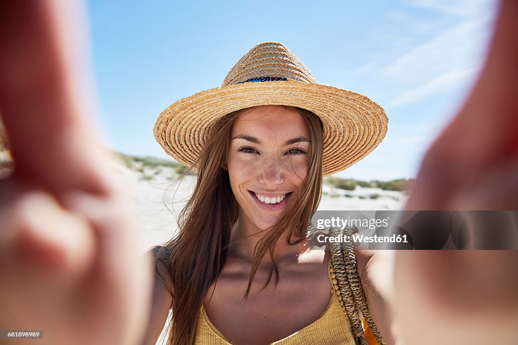 Portrait of smiling young woman on the beach