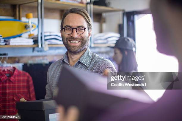 man buying shoes in fashion shop - shoe box stock pictures, royalty-free photos & images