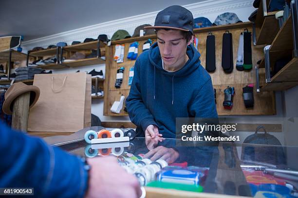 salesperson in skater shop - skateboard shop stock pictures, royalty-free photos & images