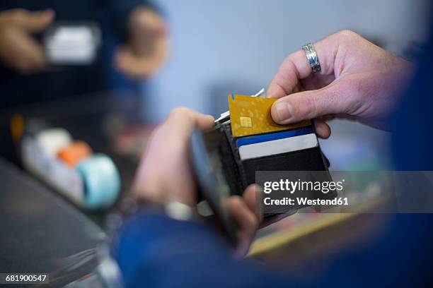 man holding wallet with cards - cartera fotografías e imágenes de stock