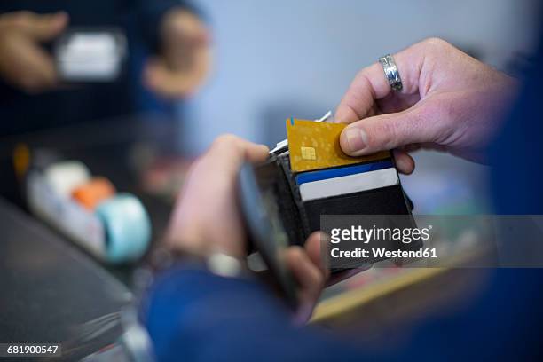 man holding wallet with cards - wallet stock pictures, royalty-free photos & images
