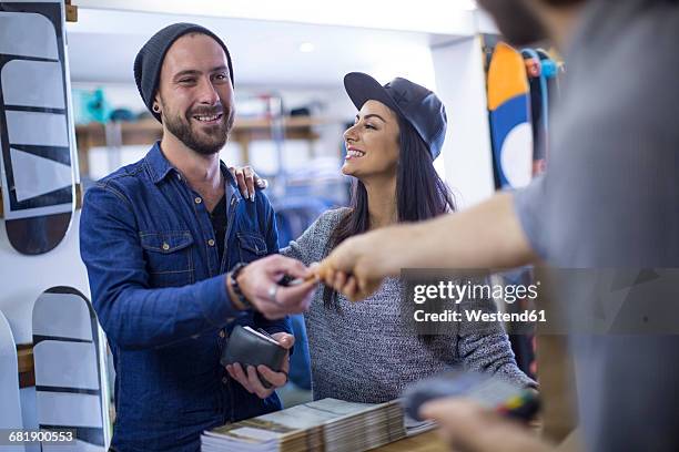 customer paying with credit card - sports equipment store stock pictures, royalty-free photos & images