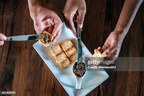 close-up of a couple eating olive pate with bread in restaurant - olivenpasten stock-fotos und bilder