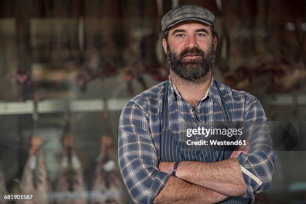 portrait of confident butcher in butchery - butchery stock-fotos und bilder