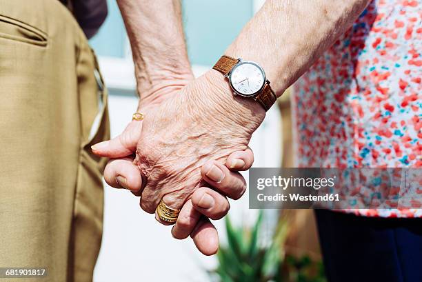 back view of senior couple holding hands, close-up - caricia fotografías e imágenes de stock