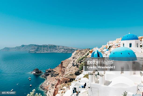 greece, santorini, oia, view to caldera and greek orthodox church - santorini stock pictures, royalty-free photos & images