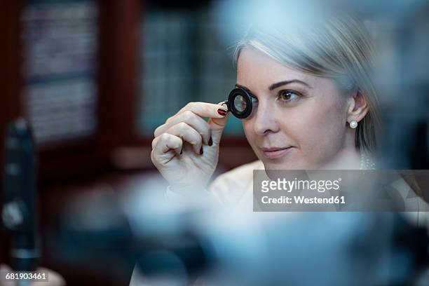 patient at optometrist trying different lenses - eye test equipment stock pictures, royalty-free photos & images
