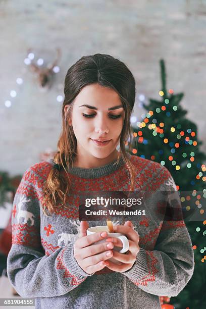 portrait of woman with cup of coffee at christmas time - christmas coffee stock-fotos und bilder