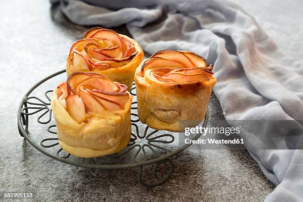 filo pastry apple cakes in rose shape on cooling grid - apple pie a la mode stock pictures, royalty-free photos & images