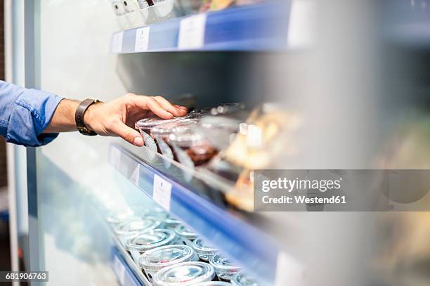hand taking food from cooling shelf - convenience food stock pictures, royalty-free photos & images