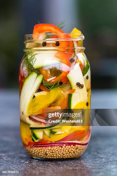 pickeled vegetables and herbs in preserving jars - pickle jar stockfoto's en -beelden