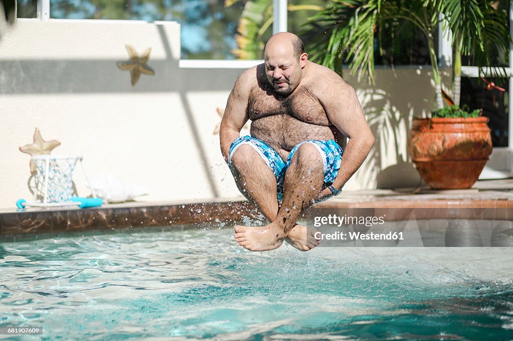 Man jumping in swimming pool