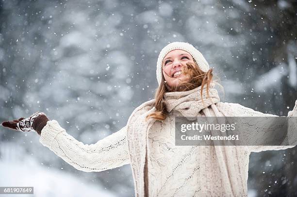 young woman having fun in snow - women winter snow stock-fotos und bilder