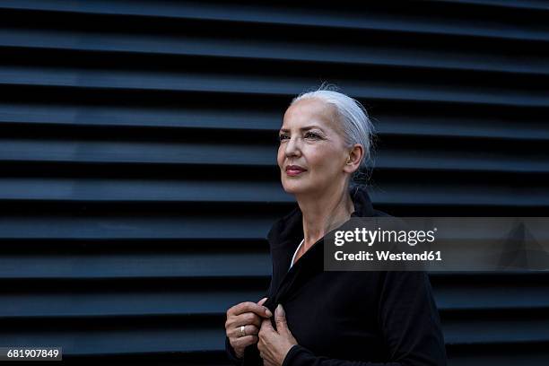 woman wearing black tracksuit top in front of black background - high contrast bildbanksfoton och bilder