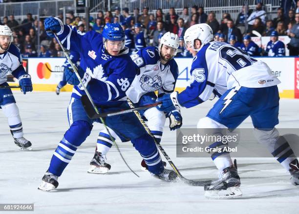 Colin Greening of the Toronto Marlies battles with Slater Koekkoek and Cory Conacher of the Syracuse Crunch during game 3 action in the Division...