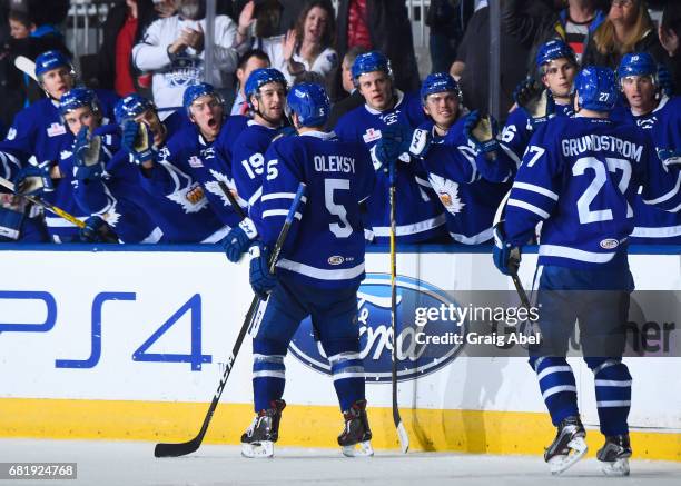 Steven Oleksy and Carl Grundstrom celebrate a late 3rd period goal with teammates against the Syracuse Crunch during game 3 action in the Division...