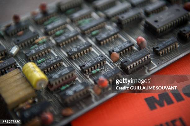 The microprocessor's card of the first microcomputer named "Micral N", is shown by the auctioneer on May 11, 2017 in Tours, ahead of an auction next...