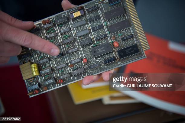 The microprocessor's card of the first microcomputer named "Micral N", is shown by the auctioneer on May 11, 2017 in Tours, ahead of an auction next...