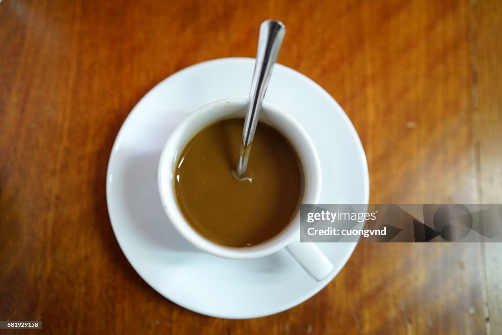 Vietnamese coffee with condensed milk cafe sua da on a wooden background