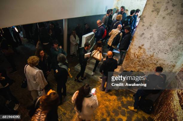 Visitors attend at the opening of the Israel pavilion, presenting the project 'Sun Stand Still' of Gal Weinstein at the 57th Biennale Arte on May 11,...