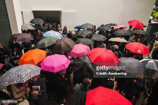 Visitors attend at the opening of the Israel pavilion, presenting the project 'Sun Stand Still' of Gal Weinstein at the 57th Biennale Arte on May 11,...