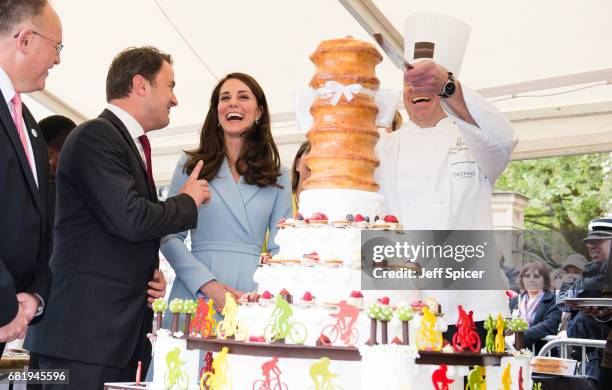 Xavier Bettel, Prime Minister of Luxembourg and Catherine, Duchess of Cambridge view a cake with a cycling design as they tour a cycling themed...