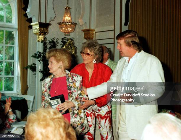 American former competative swimmer Marjorie Post Dye stands with Mary Trump and the latter's son, real estate developer Donald Trump, during an...